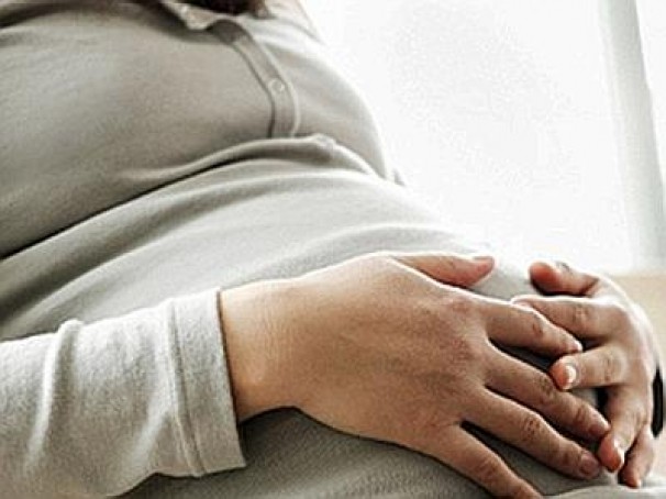 braccia conserte sul pancione di una donna in gravidanza